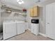 Functional laundry room featuring modern appliances, storage shelves, and ample counter space at 917 Redstone Trl, Dacula, GA 30019