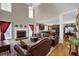 Open-concept living room with fireplace, large windows, and hardwood floors, open to the kitchen at 917 Redstone Trl, Dacula, GA 30019