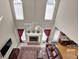 Bright, open living room with fireplace, vaulted ceiling, clerestory windows and adjacent kitchen at 917 Redstone Trl, Dacula, GA 30019