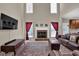 Comfortable living room featuring a cozy brick fireplace, large windows, and stylish furnishings at 917 Redstone Trl, Dacula, GA 30019