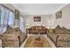 Comfortable living room with patterned sofas, a wooden coffee table, and soft natural light at 917 Redstone Trl, Dacula, GA 30019