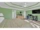 Spacious main bedroom featuring tray ceiling, large bed, workspace and ensuite bath at 917 Redstone Trl, Dacula, GA 30019
