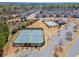 Aerial view featuring a community pool, tennis courts, and residential homes in a suburban neighborhood at 11395 Crestview Ter, Johns Creek, GA 30024