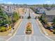 Aerial view of a gated community entrance with landscaping and well-maintained streets at 11395 Crestview Ter, Johns Creek, GA 30024