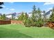 Expansive backyard with lush green lawn, mature trees, and wooden fence for privacy at 11395 Crestview Ter, Johns Creek, GA 30024