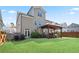 Well-maintained backyard with green grass, a wooden pergola, and privacy fence, perfect for outdoor enjoyment at 11395 Crestview Ter, Johns Creek, GA 30024