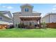Large backyard showcases a well-manicured lawn, pergola with outdoor seating, and a privacy fence at 11395 Crestview Ter, Johns Creek, GA 30024