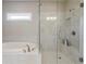 Modern bathroom featuring a soaking tub and a separate glass-enclosed shower at 11395 Crestview Ter, Johns Creek, GA 30024