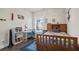 Cozy bedroom featuring natural light, a twin bed, desk, and built-in shelves at 11395 Crestview Ter, Johns Creek, GA 30024