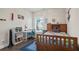 Well-lit bedroom with desk, bookshelf, and a wooden bed frame at 11395 Crestview Ter, Johns Creek, GA 30024