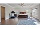 Bright primary bedroom suite with tray ceiling and hardwood floors at 11395 Crestview Ter, Johns Creek, GA 30024