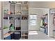 Spacious walk-in closet with built-in storage solutions including shelving and hanging rods at 11395 Crestview Ter, Johns Creek, GA 30024