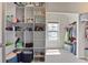 Large walk-in closet with custom shelving, providing efficient storage solutions and maximizing space at 11395 Crestview Ter, Johns Creek, GA 30024