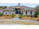 Inviting clubhouse entrance with manicured landscaping and pedestrian walkway at 11395 Crestview Ter, Johns Creek, GA 30024