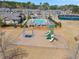 Aerial view showing a community pool, tennis courts, and a playground in a residential area at 11395 Crestview Ter, Johns Creek, GA 30024