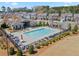 A pristine community pool with a clubhouse, surrounded by neatly arranged lounge chairs at 11395 Crestview Ter, Johns Creek, GA 30024