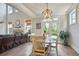 Light-filled dining area featuring a modern chandelier and access to the outdoors at 11395 Crestview Ter, Johns Creek, GA 30024