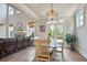 Open concept dining room looking to a living area with large ceilings and fireplace at 11395 Crestview Ter, Johns Creek, GA 30024