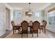 Traditional dining room with wainscoting, hardwood floors, a chandelier, and space for Gathering gatherings at 11395 Crestview Ter, Johns Creek, GA 30024