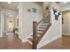 Elegant foyer with hardwood floors, a staircase, crown molding, and stylish decor leading into the home at 11395 Crestview Ter, Johns Creek, GA 30024
