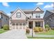 Charming two-story home with a brick and siding exterior, a well-manicured lawn, and an attached two-car garage at 11395 Crestview Ter, Johns Creek, GA 30024