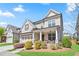 Charming two-story home with a welcoming front porch, attached garage, and professionally landscaped yard at 11395 Crestview Ter, Johns Creek, GA 30024