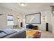 Spacious game room features a large screen, shiplap accent wall, and colorful rug for Gathering entertainment at 11395 Crestview Ter, Johns Creek, GA 30024
