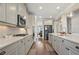 Stylish kitchen with stainless steel appliances, white cabinets and subway tile backsplash at 11395 Crestview Ter, Johns Creek, GA 30024