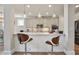Modern kitchen with white cabinets, a quartz countertop, stainless steel appliances, and a breakfast bar at 11395 Crestview Ter, Johns Creek, GA 30024