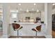 Contemporary kitchen with white cabinets, stainless steel appliances, and a breakfast bar at 11395 Crestview Ter, Johns Creek, GA 30024