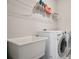 Laundry room with sink, washer, dryer, and shelf at 11395 Crestview Ter, Johns Creek, GA 30024