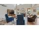 Spacious living room featuring a fireplace, modern furniture, and hardwood floors at 11395 Crestview Ter, Johns Creek, GA 30024