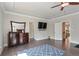 Bright main bedroom suite with tray ceiling, hardwood floors and dresser at 11395 Crestview Ter, Johns Creek, GA 30024