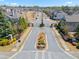 Aerial view of a well-maintained neighborhood featuring tree-lined streets and a gated entrance at 11395 Crestview Ter, Johns Creek, GA 30024