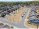 An aerial shot captures a well-planned neighborhood with lush green spaces, tree-lined streets, and neatly arranged homes at 11395 Crestview Ter, Johns Creek, GA 30024