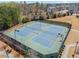 Aerial view of tennis courts, surrounded by landscaping and lighting fixtures at 11395 Crestview Ter, Johns Creek, GA 30024