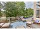 Inviting outdoor deck featuring comfortable seating and scenic backyard views of the surrounding greenery at 1718 Autumn Sage Dr, Dacula, GA 30019