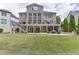 Expansive backyard featuring a multi-level deck, manicured lawn, and outdoor seating, perfect for relaxation at 1718 Autumn Sage Dr, Dacula, GA 30019