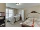 Cozy carpeted bedroom with natural light, furnishings, and an air hockey table at 1718 Autumn Sage Dr, Dacula, GA 30019