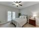 This bedroom is brightly lit with natural light and carpeted flooring at 1718 Autumn Sage Dr, Dacula, GA 30019