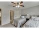 Bedroom featuring two beds, carpet, and a ceiling fan at 1718 Autumn Sage Dr, Dacula, GA 30019