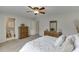Bedroom featuring carpet, a ceiling fan, and an ensuite bathroom at 1718 Autumn Sage Dr, Dacula, GA 30019