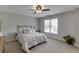 Bright bedroom featuring a bed, carpet, and a ceiling fan at 1718 Autumn Sage Dr, Dacula, GA 30019