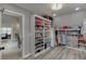 View of walk-in closet and bathroom with custom closet system at 1718 Autumn Sage Dr, Dacula, GA 30019