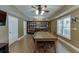 Open basement dining area with a built-in bar, wood floors, and natural light from windows at 1718 Autumn Sage Dr, Dacula, GA 30019