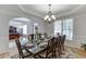 Bright dining room with decorative chandelier, a large table, and hardwood floors at 1718 Autumn Sage Dr, Dacula, GA 30019