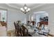Formal dining room features wainscoting, chair rail and a large table with seating for ten at 1718 Autumn Sage Dr, Dacula, GA 30019