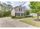 Beautiful home exterior featuring lush landscaping, a long driveway, and classic architectural details at 1718 Autumn Sage Dr, Dacula, GA 30019