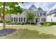 Charming two-story home with a well-manicured lawn, inviting front porch, and classic brick facade at 1718 Autumn Sage Dr, Dacula, GA 30019