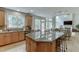 Open kitchen layout with granite counters, an island with seating, and hardwood flooring at 1718 Autumn Sage Dr, Dacula, GA 30019